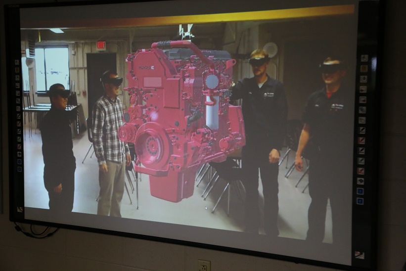 Members of our Learning Innovations team join instructors in testing a new virtual reality diesel engine.